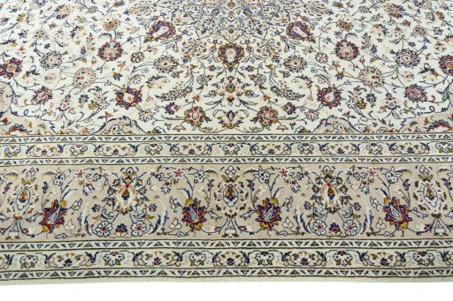 Corner detail of 2000s Kashan rug showing border pattern and Wool pile