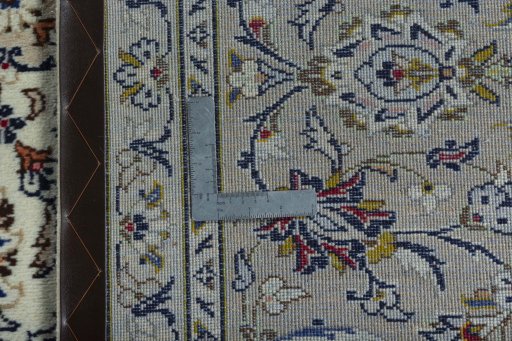Backside of handmade 2000s Kashan rug showing knot structure and weave density