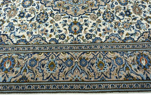 Corner detail of 2000s Kashan rug showing border pattern and Wool pile