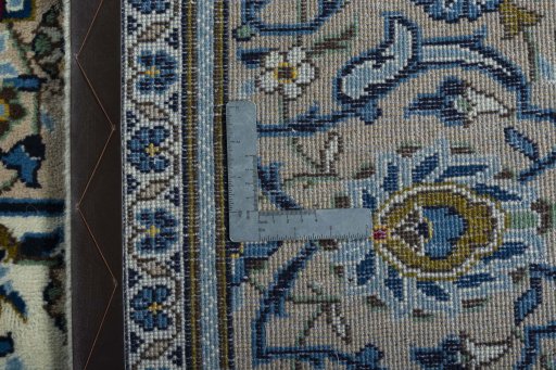 Backside of handmade 2000s Kashan rug showing knot structure and weave density