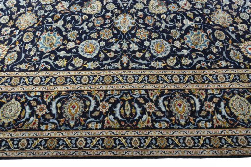 Corner detail of 2000s Kashan rug showing border pattern and Wool pile
