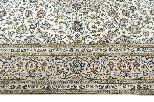 Corner detail of 2000s Kashan rug showing border pattern and Wool pile
