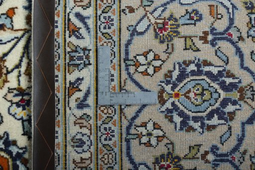 Backside of handmade 2000s Kashan rug showing knot structure and weave density
