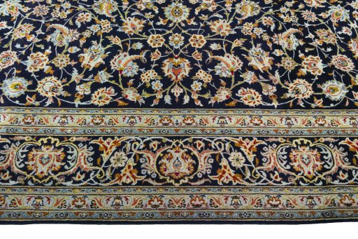 Corner detail of 2000s Kashan rug showing border pattern and Wool pile