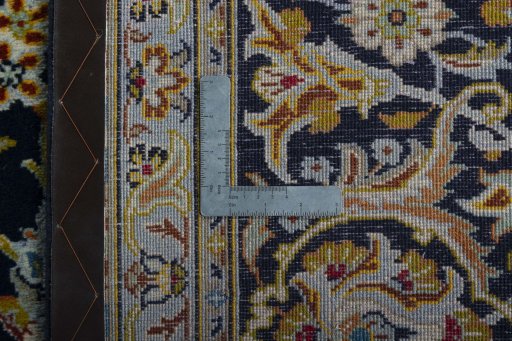 Backside of handmade 2000s Kashan rug showing knot structure and weave density