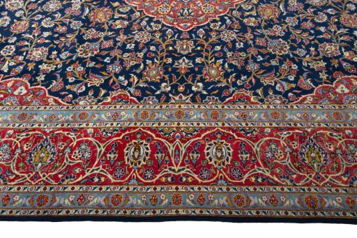 Corner detail of 2000s Kashan rug showing border pattern and Cork pile