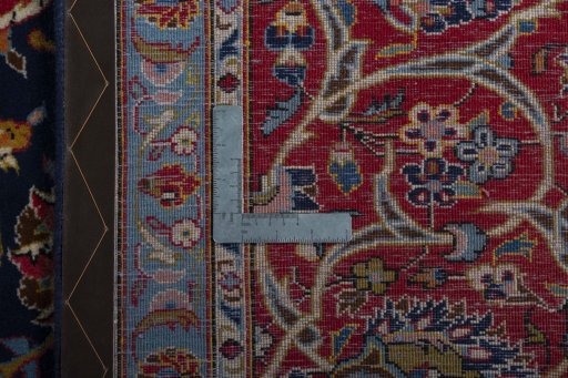 Backside of handmade 2000s Kashan rug showing knot structure and weave density