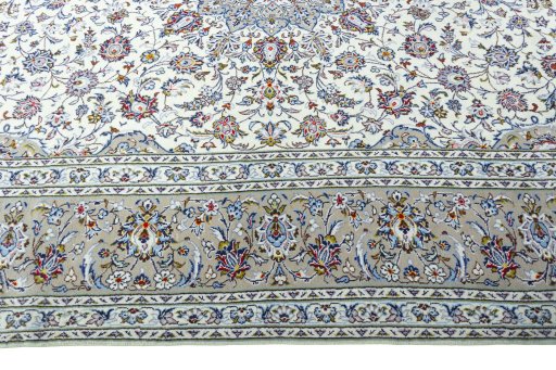 Corner detail of 2000s Kashan rug showing border pattern and Wool pile