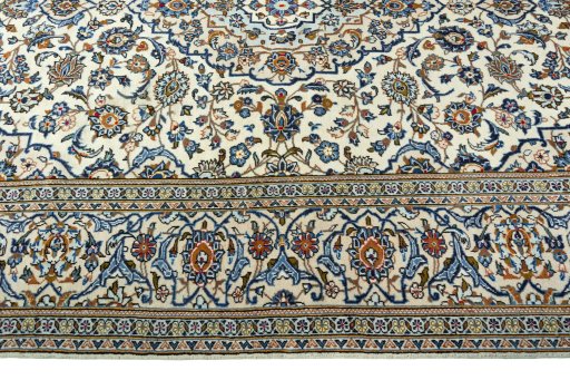 Corner detail of 2000s Kashan rug showing border pattern and Wool pile