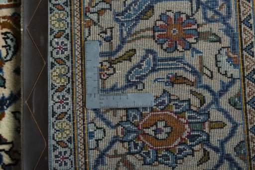 Backside of handmade 2000s Kashan rug showing knot structure and weave density