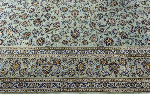 Corner detail of 2000s Kashan rug showing border pattern and Wool pile