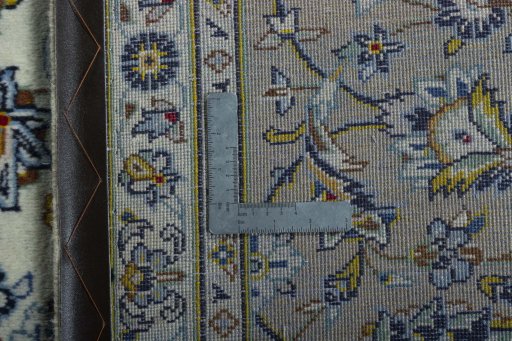 Backside of handmade 2000s Kashan rug showing knot structure and weave density