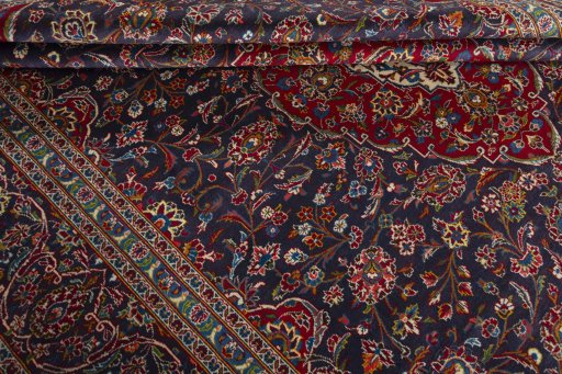 Close-up detail of 2000s Kashan rug from Iran / Persia showing Wool weave