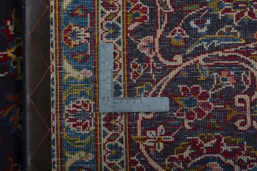 Backside of handmade 2000s Kashan rug showing knot structure and weave density