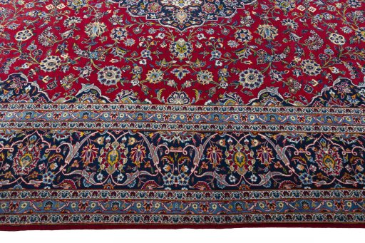 Corner detail of 2000s Kashan rug showing border pattern and Wool pile