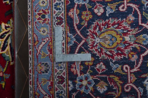 Backside of handmade 2000s Kashan rug showing knot structure and weave density