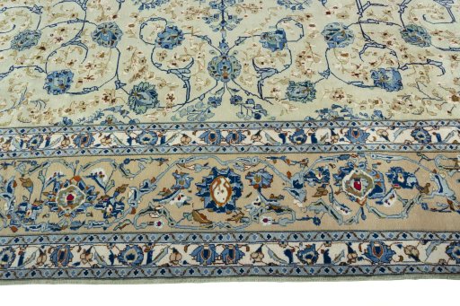 Corner detail of 2000s Kashan rug showing border pattern and Wool pile