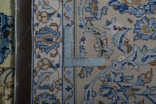 Backside of handmade 2000s Kashan rug showing knot structure and weave density
