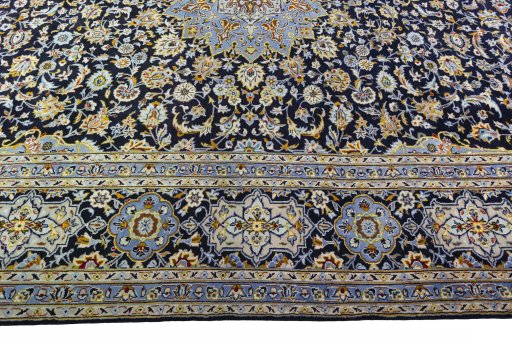 Corner detail of 2000s Kashan rug showing border pattern and Wool pile