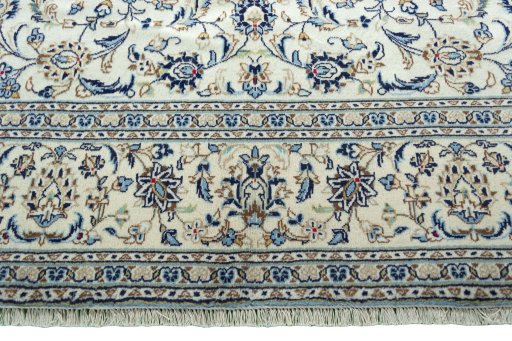 Corner detail of 2000s Kashan rug showing border pattern and Wool pile