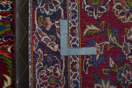 Corner detail of 2000s Kashan rug showing border pattern and Wool pile