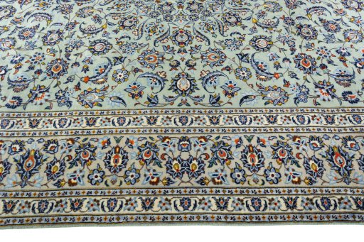 Corner detail of 2000s Kashan rug showing border pattern and Wool pile