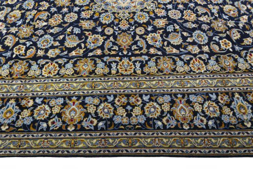 Corner detail of 2000s Kashan rug showing border pattern and Wool pile