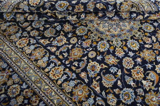 Close-up detail of 2000s Kashan rug from Iran / Persia showing Wool weave