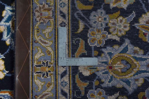 Backside of handmade 2000s Kashan rug showing knot structure and weave density