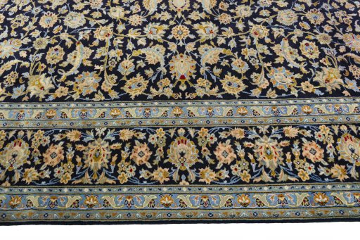 Corner detail of 2000s Kashan rug showing border pattern and Wool pile