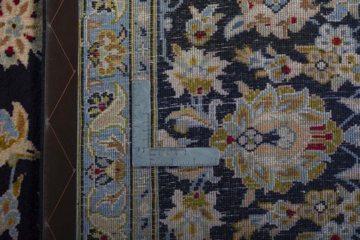 Backside of handmade 2000s Kashan rug showing knot structure and weave density