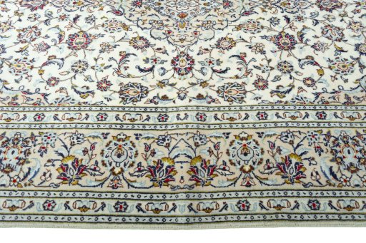 Corner detail of 2000s Kashan rug showing border pattern and Wool pile