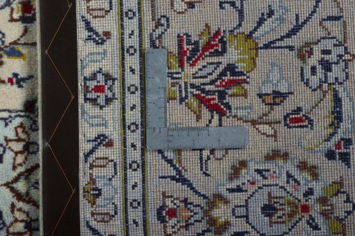 Backside of handmade 2000s Kashan rug showing knot structure and weave density