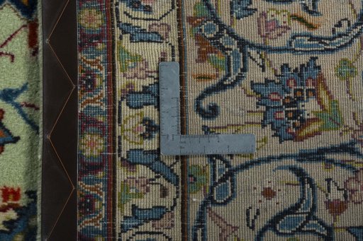Backside of handmade 2000s Kashan rug showing knot structure and weave density