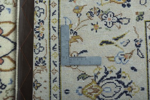 Backside of handmade 2000s Kashan rug showing knot structure and weave density