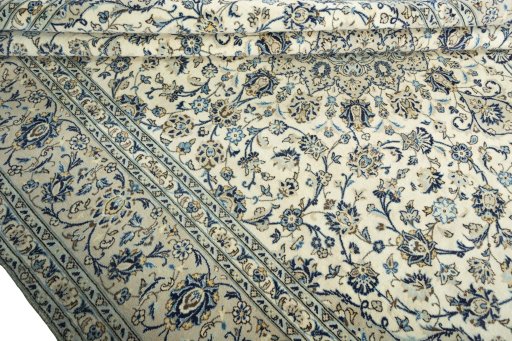 Corner detail of 2000s Kashan rug showing border pattern and Wool pile