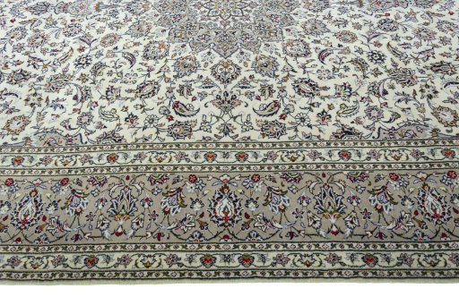 Corner detail of 2000s Kashan rug showing border pattern and Wool pile