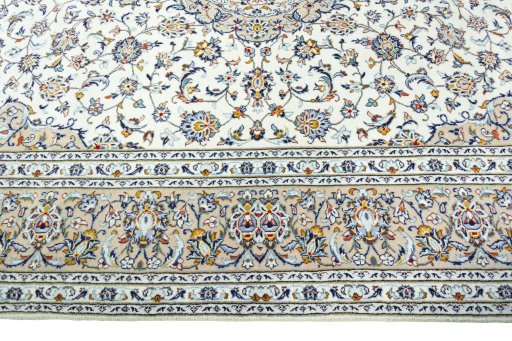 Corner detail of 2000s Kashan rug showing border pattern and Wool pile