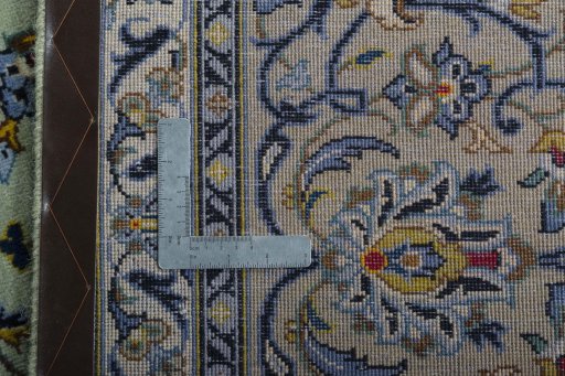 Backside of handmade 2000s Kashan rug showing knot structure and weave density