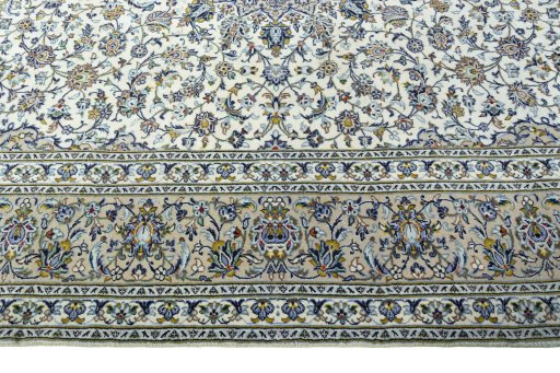 Corner detail of 2000s Kashan rug showing border pattern and Wool pile