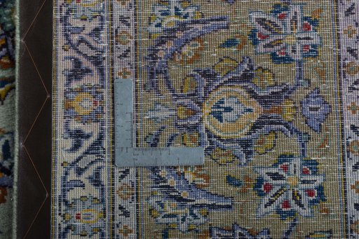 Backside of handmade 2000s Kashan rug showing knot structure and weave density