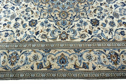 Corner detail of 2000s Kashan rug showing border pattern and Wool pile