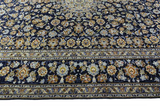 Corner detail of 2000s Kashan rug showing border pattern and Wool pile