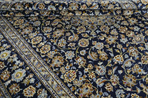 Close-up detail of 2000s Kashan rug from Iran / Persia showing Wool weave