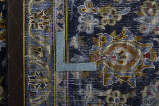 Backside of handmade 2000s Kashan rug showing knot structure and weave density