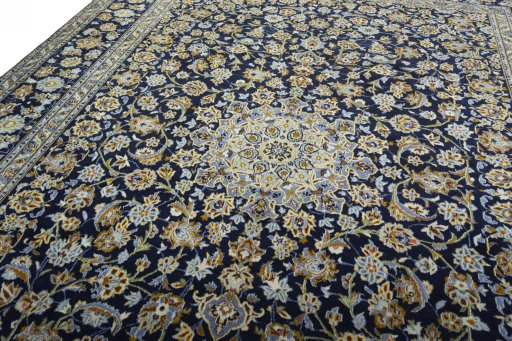 Backside of handmade 2000s Kashan rug showing knot structure and weave density