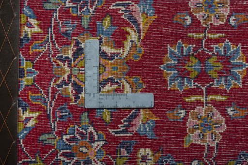 Backside of handmade 2000s Kashan rug showing knot structure and weave density