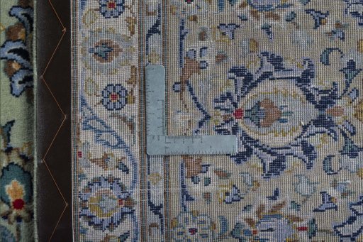 Backside of handmade 2000s Kashan rug showing knot structure and weave density