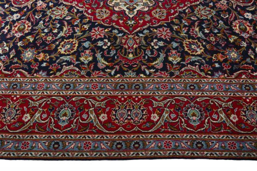 Corner detail of 2000s Kashan rug showing border pattern and Wool pile