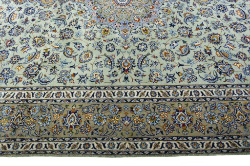 Corner detail of 2000s Kashan rug showing border pattern and Wool pile